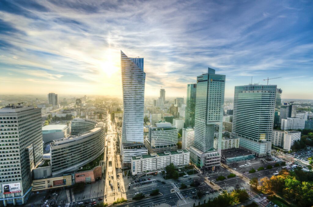 Breathtaking aerial view of Warsaw's modern skyline during sunset showcasing urban architecture.
